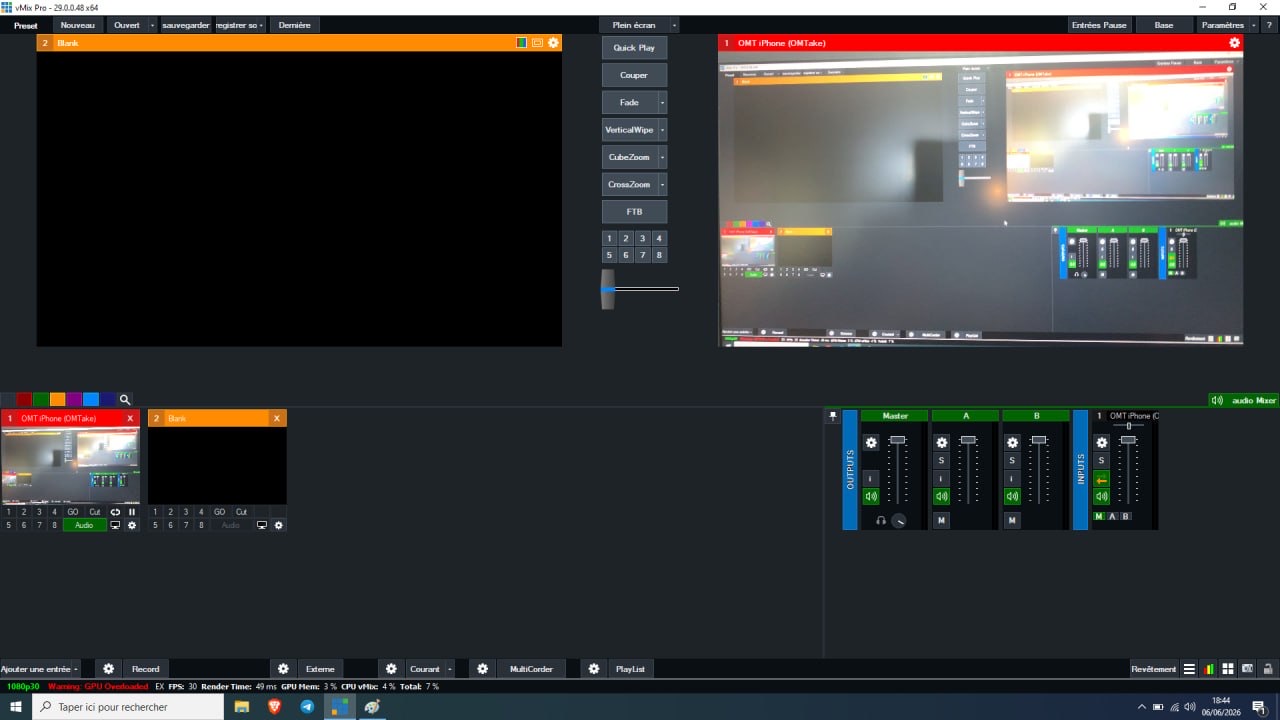 vMix with the OMT iPhone input in Program, showing the live iPhone camera feed and its audio channel in the mixer.